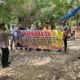 Personel Kepolisian saat bentang spanduk himbauan. , Sabtu (12/03/2022). (Foto/Humas).