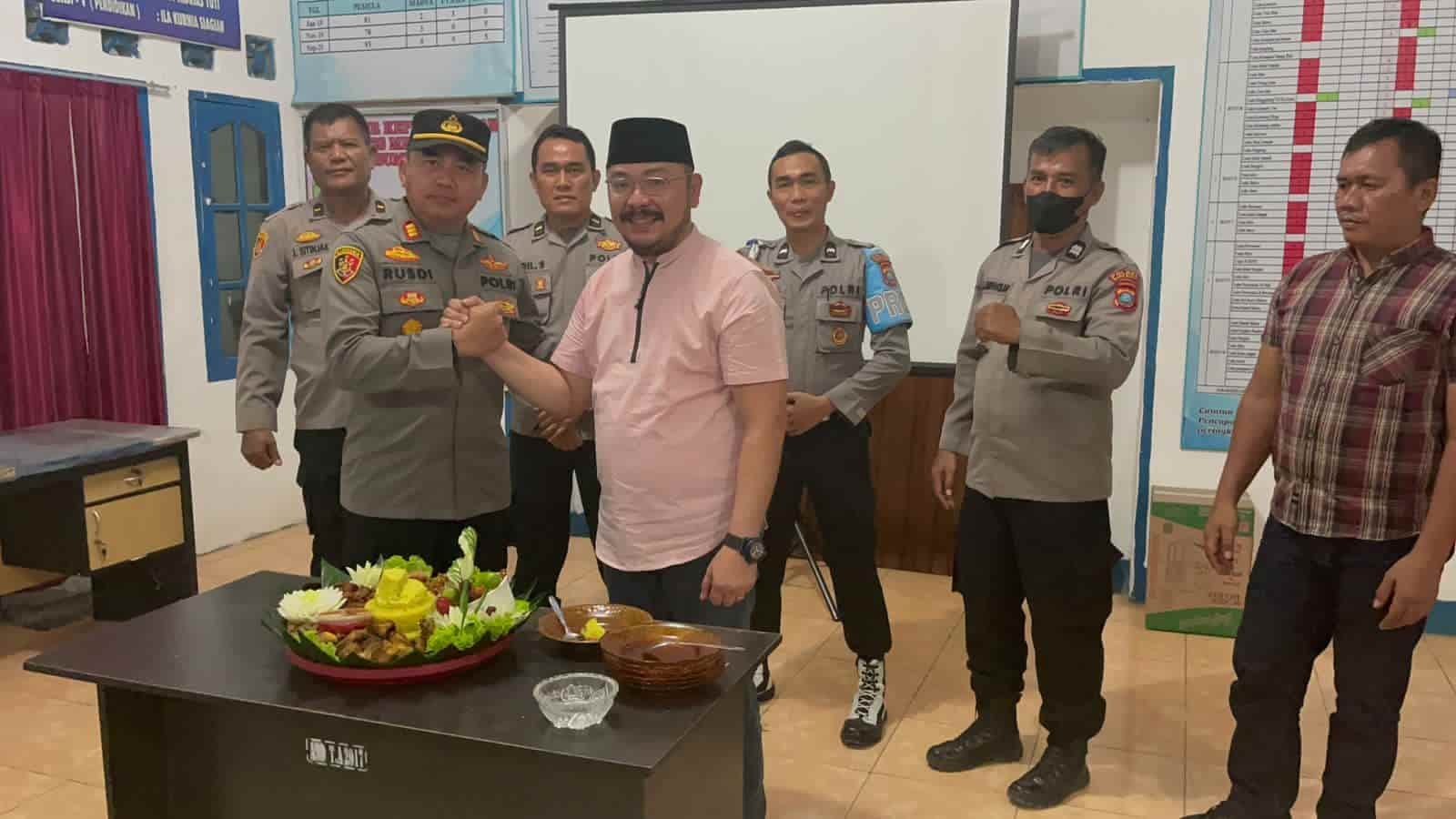 Kapolsek Lima Puluh, AKP Rusdi bersama Camat Lima Puluh, Adri Aulia, usai memotong nasi tumpeng, syukuran HUT Bhayangkara ke 76