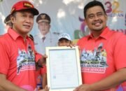 Turut Meriahkan HUT Kota Medan, Kakanwil Kemenkumham Sumut Serahkan Pencatatan Hak Cipta Kepada Wali Kota
