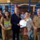Camat Siempat Nempu, Binuar Malau saat menyerahkan akta pernikahan pengantin baru didesa Jumateguh, Selasa (2/7/2024).(kedanmews.com/Sondang Silalahi).